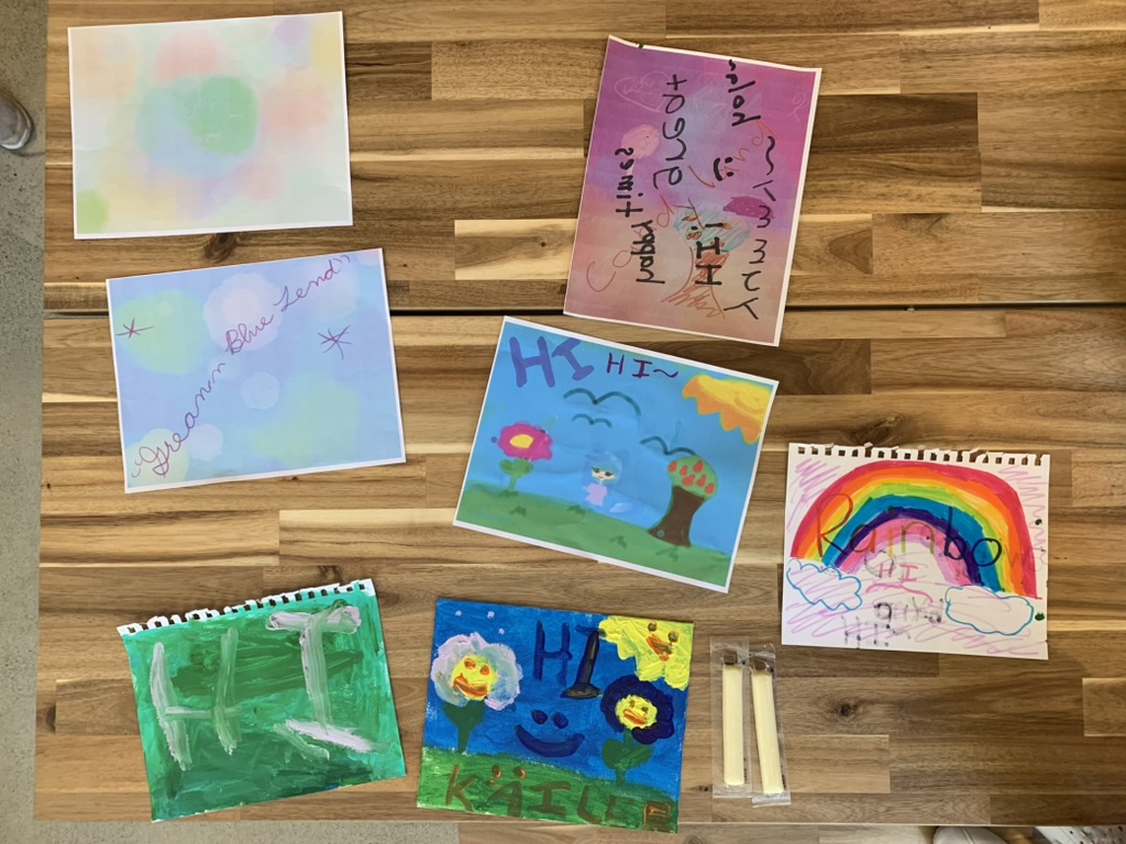 Student artwork spread out on a table